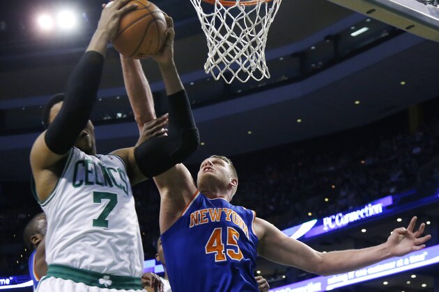 New York Knicks center Cole Aldrich (45) battles for a rebound with Boston Celtics center Jared Sullinger (7) during the first quarter of an NBA basketball game in Boston, Wednesday, March 12, 2014. Aldrich had 12 points with 10 rebounds in his first career start for the Knicks who won 116-92. (AP Photo/Elise Amendola)