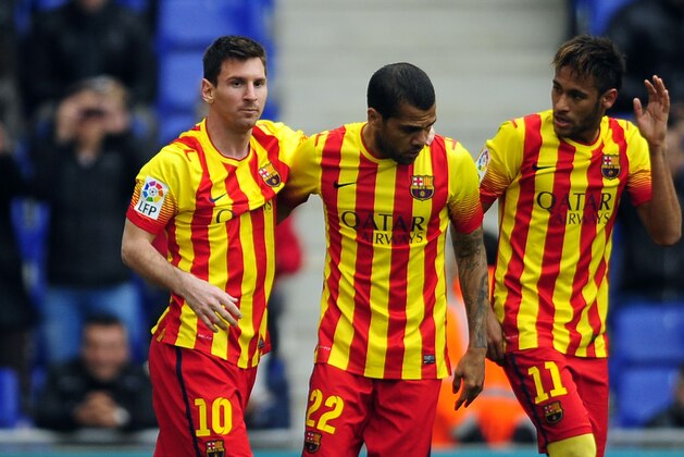 FC Barcelona's Lionel Messi, left, celebrates after scoring a penalty with teammates Neymar, right, and Daniel Alves, center, during a Spanish La Liga soccer match against Espanyol at Cornella-El Prat stadium in Cornella Llobregat, Spain, Saturday, March 29, 2014. (AP Photo/Manu Fernandez)