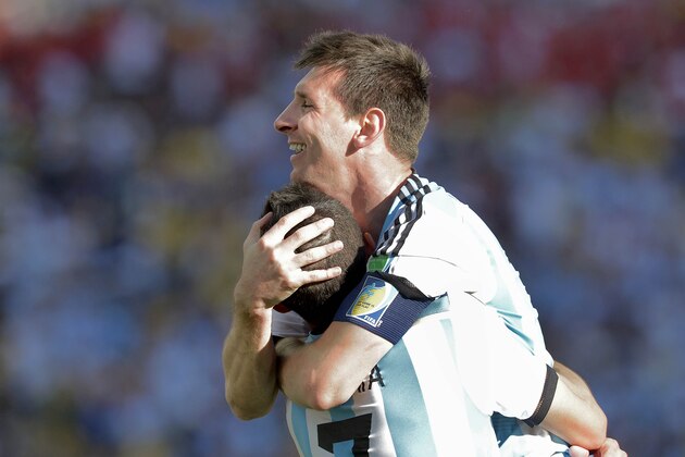Argentina's Lionel Messi celebrates with Angel di Maria after di Maria scored his side's only and winning goal in extra time during the World Cup round of 16 soccer match between Argentina and Switzerland at the Itaquerao Stadium in Sao Paulo, Brazil, Tuesday, July 1, 2014. Argentina defeated Switzerland 1-0 to move on to the quarterfinals. (AP Photo/Manu Fernandez)