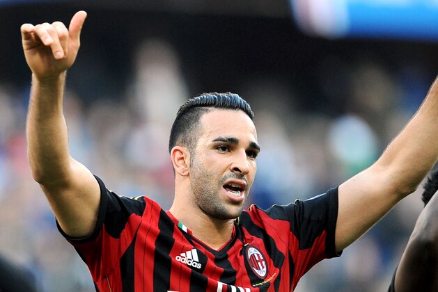 AC Milan's Adil Rami, left, and teammate Michael Essien celebrate at the end of a Serie A soccer match between Sampdoria and AC Milan, at the Luigi Ferraris stadium in Genoa, Italy, Sunday, Feb. 23, 2014. AC Milan won 2-0. (AP Photo/Carlo Baroncini)