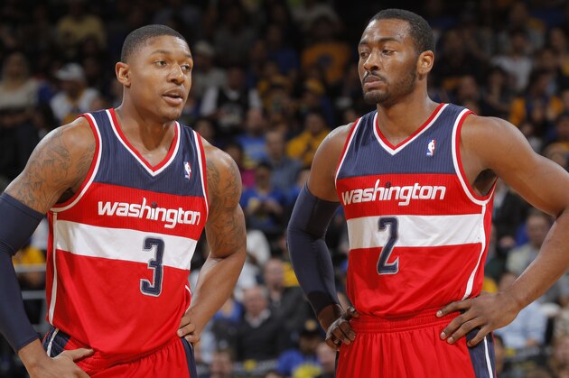 OAKLAND, CA - JANUARY 28: Bradley Beal #3 chats with teammate John Wall #2 of the Washington Wizards while facing the Golden State Warriors on January 28, 2014 at Oracle Arena in Oakland, California. NOTE TO USER: User expressly acknowledges and agrees that, by downloading and or using this photograph, user is consenting to the terms and conditions of Getty Images License Agreement. Mandatory Copyright Notice: Copyright 2014 NBAE (Photo by Rocky Widner/NBAE via Getty Images)