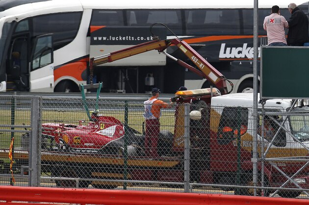 The car of Finland's Kimi Raikkonen of Ferrari is being take back to the pits after the driver crashed during the British Formula 1 Grand Prix at Silverstone circuit, Silverstone, England, Sunday, July 6, 2014. The British Grand Prix was halted on the opening lap Sunday after a collision involving Raikkonen and Felipe Massa of Williams. Massa escaped unhurt and drove back to the pits without his left rear wheel, but Raikkonen emerged limping from his smashed Ferrari that had lost most of the front end and left rear wheel. The race was stopped as 2007 champion Raikkonen was taken to the circuit medical center. He appears to have lost control of his car and hit the barriers before spinning across the track where he collided with Massa. (AP Photo/Lefteris Pitarakis)