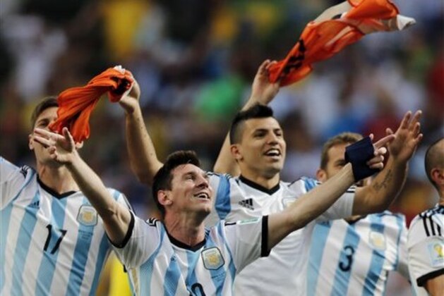 CORRECTS PHOTOGRAPHER'S BYLINE - Argentina's Lionel Messi and teammates celebrate at the end of the World Cup quarterfinal soccer match between Argentina and Belgium at the Estadio Nacional in Brasilia, Brazil, Saturday, July 5, 2014. Argentina won 1-0. (AP Photo/Eraldo Peres)