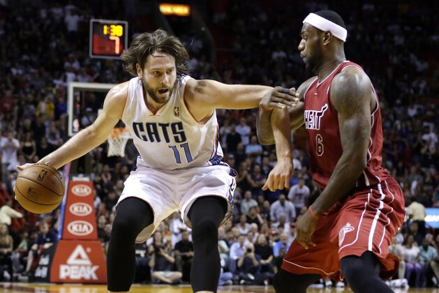 Charlotte Bobcats' Josh McRoberts (11) drives to the basket as Miami Heat's LeBron James (6) defends during the second half of an NBA basketball game Sunday, Dec. 1, 2013, in Miami. The Heat won 99-98. (AP Photo/Lynne Sladky)