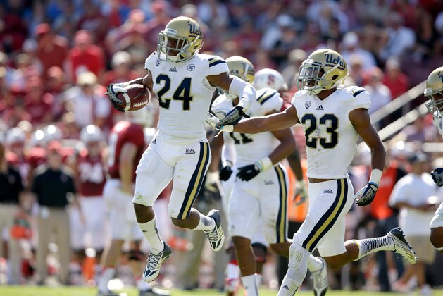 PALO ALTO, CA - OCTOBER 19:  Ishmael Adams #24 of the UCLA Bruins celebrates with Anthony Jefferson #23 of the UCLA Bruins after he intercepted a pass during their game against the Stanford Cardinal at Stanford Stadium on October 19, 2013 in Palo Alto, California.  (Photo by Ezra Shaw/Getty Images)