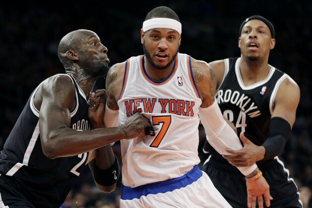 New York Knicks' Carmelo Anthony, center, fights with Brooklyn Nets' Kevin Garnett, left, and Paul Pierce for a rebound during the first half of the NBA basketball game at Madison Square Garden Monday, Jan. 20, 2014, in New York. (AP Photo/Seth Wenig)
