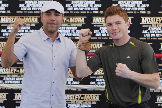 In this photo taken on on Tuesday, Sept. 14, 2010, Oscar De La Hoya, President of Golden Boy Promotions, left, presents Mexican welterweight boxer Saul