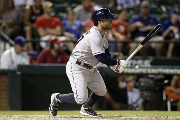 Houston Astros' Jose Altuve follows through on a hit against the Texas Rangers in a baseball game, Monday, July 7, 2014, in Arlington, Texas. (AP Photo/Tony Gutierrez)