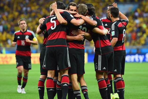 BELO HORIZONTE, BRAZIL - JULY 08:  Thomas Mueller of Germany celebrates scoring his team's first goal with teammates during the 2014 FIFA World Cup Brazil Semi Final match between Brazil and Germany at Estadio Mineirao on July 8, 2014 in Belo Horizonte, Brazil.  (Photo by Buda Mendes/Getty Images)