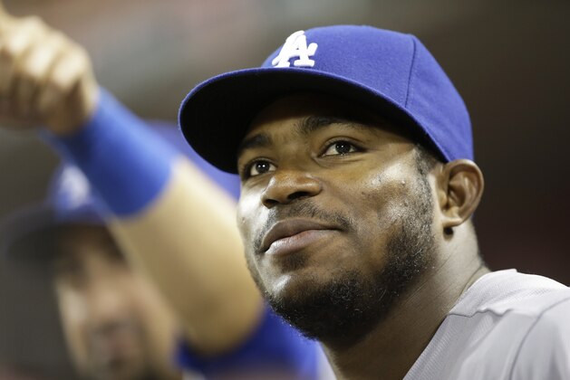 Los Angeles Dodgers' Yasiel Puig watches from the dugout during a baseball game against the Cincinnati Reds, Monday, June 9, 2014, in Cincinnati. (AP Photo/Al Behrman)