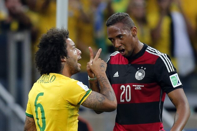 Brazil's Marcelo, left, and Germany's Jerome Boateng argue during the World Cup semifinal soccer match between Brazil and Germany at the Mineirao Stadium in Belo Horizonte, Brazil, Tuesday, July 8, 2014. (AP Photo/Frank Augstein)