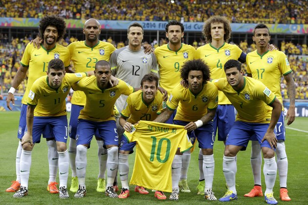 Brazil's national team holds up Neymar's jersey as they pose before the World Cup semifinal soccer match between Brazil and Germany at the Mineirao Stadium in Belo Horizonte, Brazil, Tuesday, July 8, 2014. (AP Photo/Natacha Pisarenko)