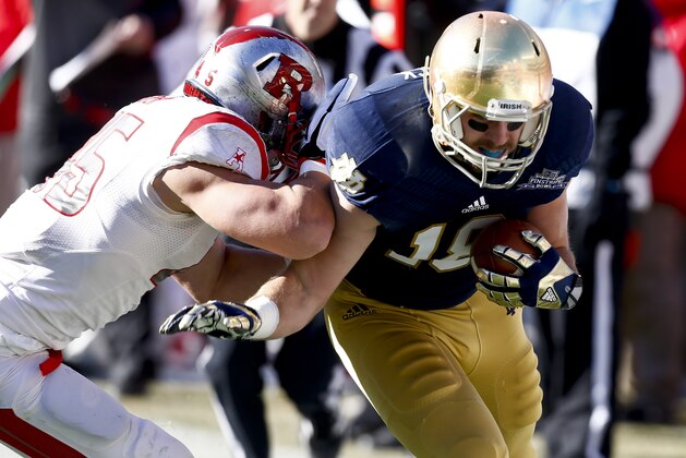 NEW YORK, NY - DECEMBER 28:  Kevin Snyder #45 of the Rutgers Scarlet Knights shoves Ben Koyack #18 of the Notre Dame Fighting Irish during the New Era Pinstripe Bowl bat Yankee Stadium on December 28, 2013 in the Bronx borough of New York City.  (Photo by Jeff Zelevansky/Getty Images)
