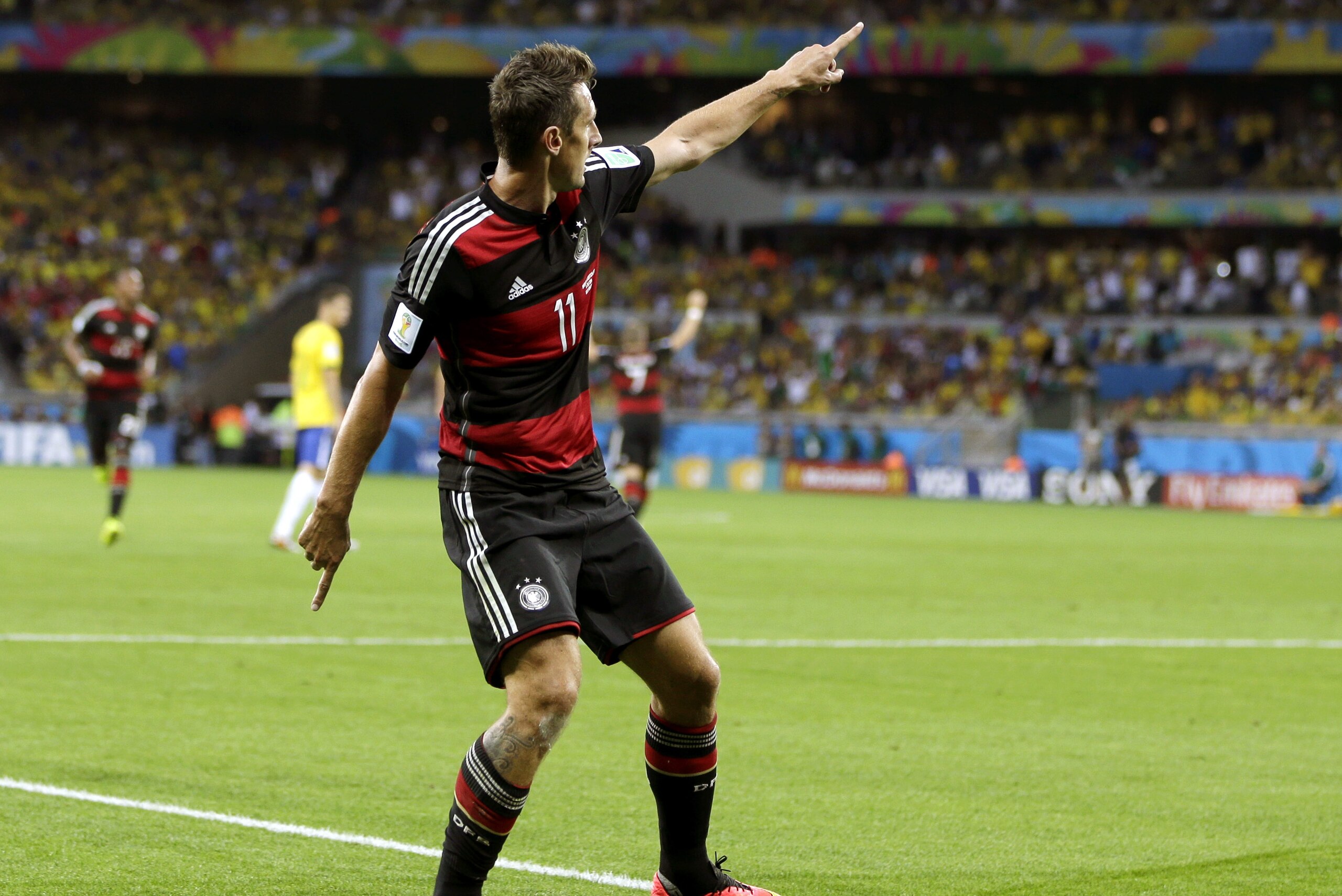 Germany's Miroslav Klose celebrates after scoring his side's second goal during the World Cup semifinal soccer match between Brazil and Germany at the Mineirao Stadium in Belo Horizonte, Brazil, Tuesday, July 8, 2014. (AP Photo/Andre Penner)
