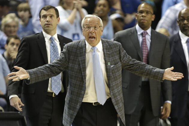 North Carolina head coach Roy Williams, center, argues a call during the second half of an NCAA college basketball game against Pittsburgh in the quarterfinal round of the Atlantic Coast Conference tournament in Greensboro, N.C., Friday, March 14, 2014.(AP Photo/Bob Leverone)