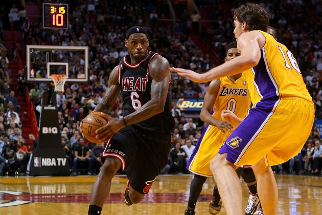 MIAMI, FL - JANUARY 23:  LeBron James #6 of the Miami Heat drives on Pau Gasol #16 of the Los Angeles Lakers during a game at American Airlines Arena on January 23, 2014 in Miami, Florida. NOTE TO USER: User expressly acknowledges and agrees that, by downloading and/or using this photograph, user is consenting to the terms and conditions of the Getty Images License Agreement. Mandatory copyright notice:  (Photo by Mike Ehrmann/Getty Images)