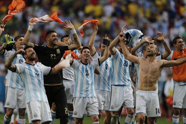 Argentina's Lionel Messi and teammates celebrate at the end of the World Cup quarterfinal soccer match between Argentina and Belgium at the Estadio Nacional in Brasilia, Brazil, Saturday, July 5, 2014. Argentina won 1-0. (AP Photo/Eraldo Peres)