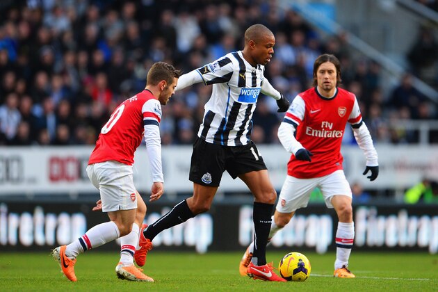 NEWCASTLE UPON TYNE, ENGLAND - DECEMBER 29: Loic Remy of  Newcastle United is closed down by Jack Wilshere (L) and Tomas Rosicky of Arsenal during the Barclays Premier League match between Newcastle United and Arsenal at St James' Park on December 29, 2013 in Newcastle upon Tyne, England.  (Photo by Michael Regan/Getty Images)