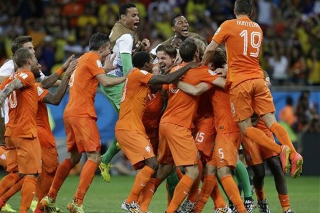 Netherlands' players celebrate after winning on penalty kicks the World Cup quarterfinal soccer match between the Netherlands and Costa Rica at the Arena Fonte Nova in Salvador, Brazil, Saturday, July 5, 2014. The Netherlands won 4-3.  Late substitute Tim Krul, center right, made two saves in a 4-3 penalty shootout victory over Costa Rica on Saturday to give the Netherlands a spot in the World Cup semifinals following a 0-0 draw.(AP Photo/Hassan Ammar)