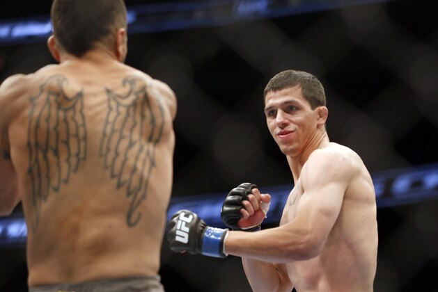 Estevan Payan, left, and Alex White fight in a mixed martial arts event on Saturday, April 19, 2014, at UFC Fight Night in Orlando Fla.. White won. (AP Photo/Reinhold Matay)