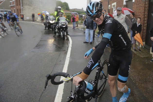 Britain's Christopher Froome grimaces as he gets up after a third consecutive crash in two days prior to abandoning the race during the fifth stage of the Tour de France cycling race over 155 kilometers (96.3 miles) with start in Ypres, Belgium, and finish in Arenberg, France, Wednesday, July 9, 2014. The stage initially contained nine sectors of cobblestone roads dreaded by the majority of the riders in the pack especially under wet conditions, the organization decided to cancel two of the nine stretches because of the weather. (AP Photo/Laurent Cipriani)