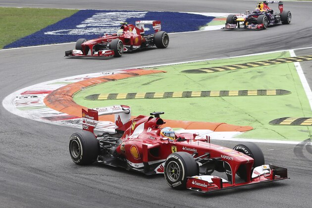 Ferrari drivers Fernando Alonso, bottom, of Spain, leads teammate Felipe Massa, of Brazil, and Red Bull driver Mark Webber, of Australia, during the Italian Grand Prix, at the Monza Formula One circuit, in Monza, Italy, Sunday, Sept. 8, 2013.  (AP Photo/Antonio Calanni)
