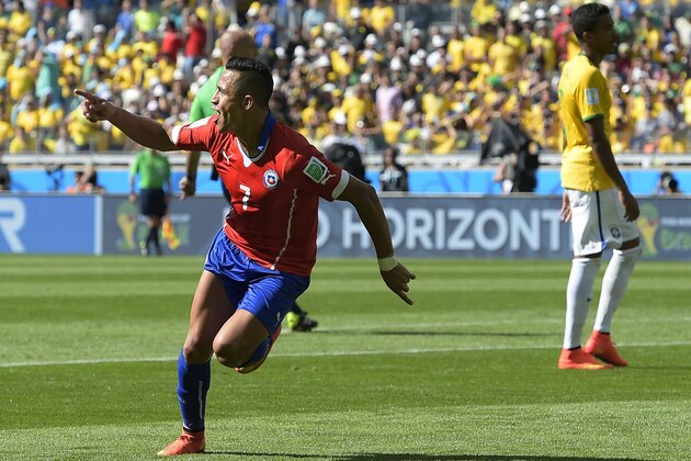 Chile's Alexis Sanchez celebrates after scoring his side's first goal during the World Cup round of 16 soccer match between Brazil and Chile at the Mineirao Stadium in Belo Horizonte, Brazil, Saturday, June 28, 2014. (AP Photo/Manu Fernandez)
