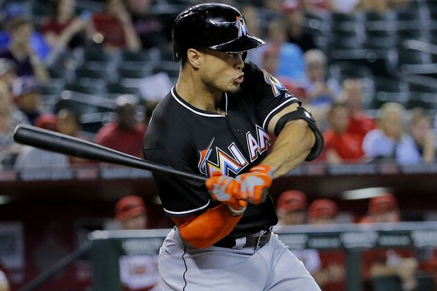 Florida Marlins' Giancarlo Stanton hits against the Arizona Diamondbacks during the first inning of a baseball game, Monday, July 7, 2014, in Phoenix. (AP Photo/Matt York)