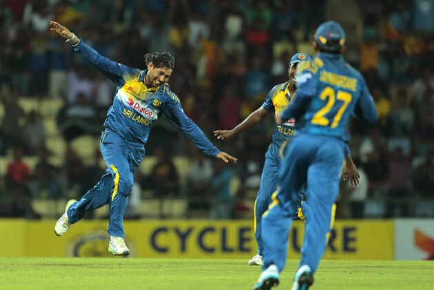 Sri Lankan bowler Tillakaratne Dilshan, left, celebrates the dismissal of South African batsman Vernon Philander during the second one-day international cricket match between Sri Lanka and South Africa in Pallekele, Sri Lanka, Wednesday, July 9, 2014. (AP Photo/Eranga Jayawardena)