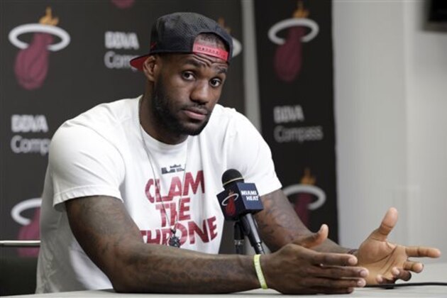 FILE - In this June 17, 2014 file photo, Miami Heat's LeBron James gestures as he answers a question during a news conference in Miami. LeBron James held meetings for more than three hours in a Las Vegas hotel Tuesday, July 8, 2014 leaving without giving any indication of what team he’ll play for next season. (AP Photo/Alan Diaz, File)
