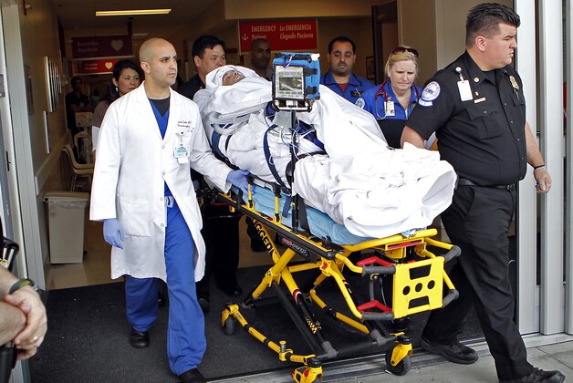 Bryan Stow, a Santa Clara, Calif., area paramedic,  who suffered brain damage in an attack on opening day of the Dodgers opener in March with his neurosurgeon Dr. Gabriel Zada, left, the LAC-USC medical team and the air and ground transport team move him to a waiting ambulance  Monday May 16, 2011, at the County USC Medical Center Emergency Room Ambulance entrance Monday morning for transport to Burbank airport where he will be flown to San Francisco. (AP Photo/Al Seib,Pool)**MANDATORY CREDIT**