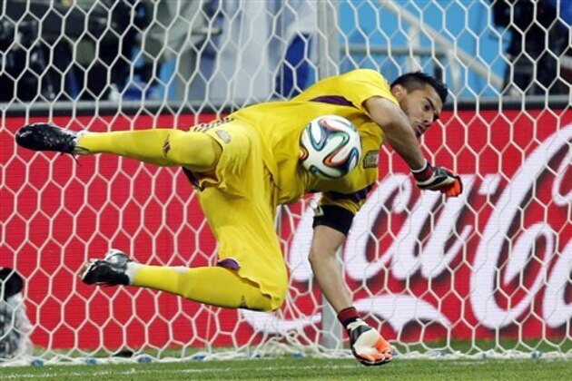 Argentina's goalkeeper Sergio Romero saves a shot from the penalty spot by Netherlands' Ron Vlaar in the shoot-out of the World Cup semifinal soccer match between the Netherlands and Argentina at the Itaquerao Stadium in Sao Paulo, Brazil, Wednesday, July 9, 2014. (AP Photo/Frank Augstein)