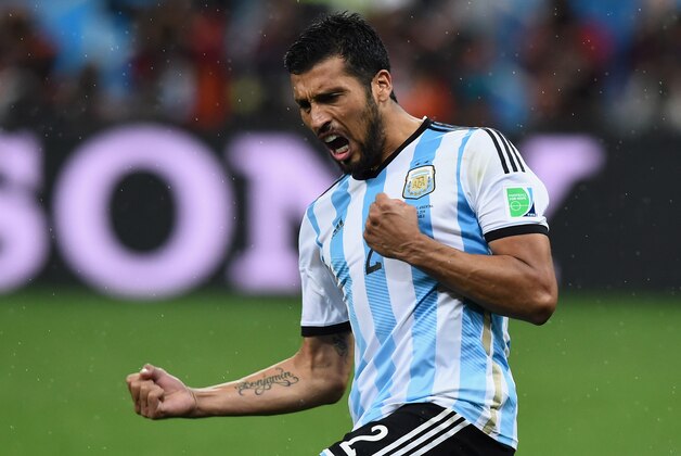 SAO PAULO, BRAZIL - JULY 09: Ezequiel Garay of Argentina celebrates scoring his penalty kick during a shootout during the 2014 FIFA World Cup Brazil Semi Final match between the Netherlands and Argentina at Arena de Sao Paulo on July 9, 2014 in Sao Paulo, Brazil. (Photo by Matthias Hangst/Getty Images) SAO PAULO, BRAZIL - JULY 09: Ezequiel Garay of Argentina celebrates scoring his penalty kick during a shootout during the 2014 FIFA World Cup Brazil Semi Final match between the Netherlands and Argentina at Arena de Sao Paulo on July 9, 2014 in Sao Paulo, Brazil. (Photo by Matthias Hangst/Getty Images)