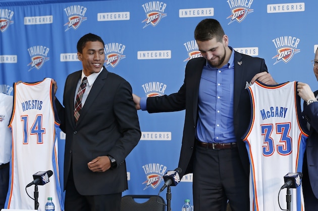 From left, Troy Weaver, Thunder vice president and assistant general manager, Thunder forward Josh Huestis, Thunder forward Mitch McGary, and Sam Presti, Thunder executive vice president and general manager, stand with basketball team jerseys as Huestis and McGary are introduced during a news conference in Oklahoma City, Friday, June 27, 2014. (AP Photo/Sue Ogrocki)
