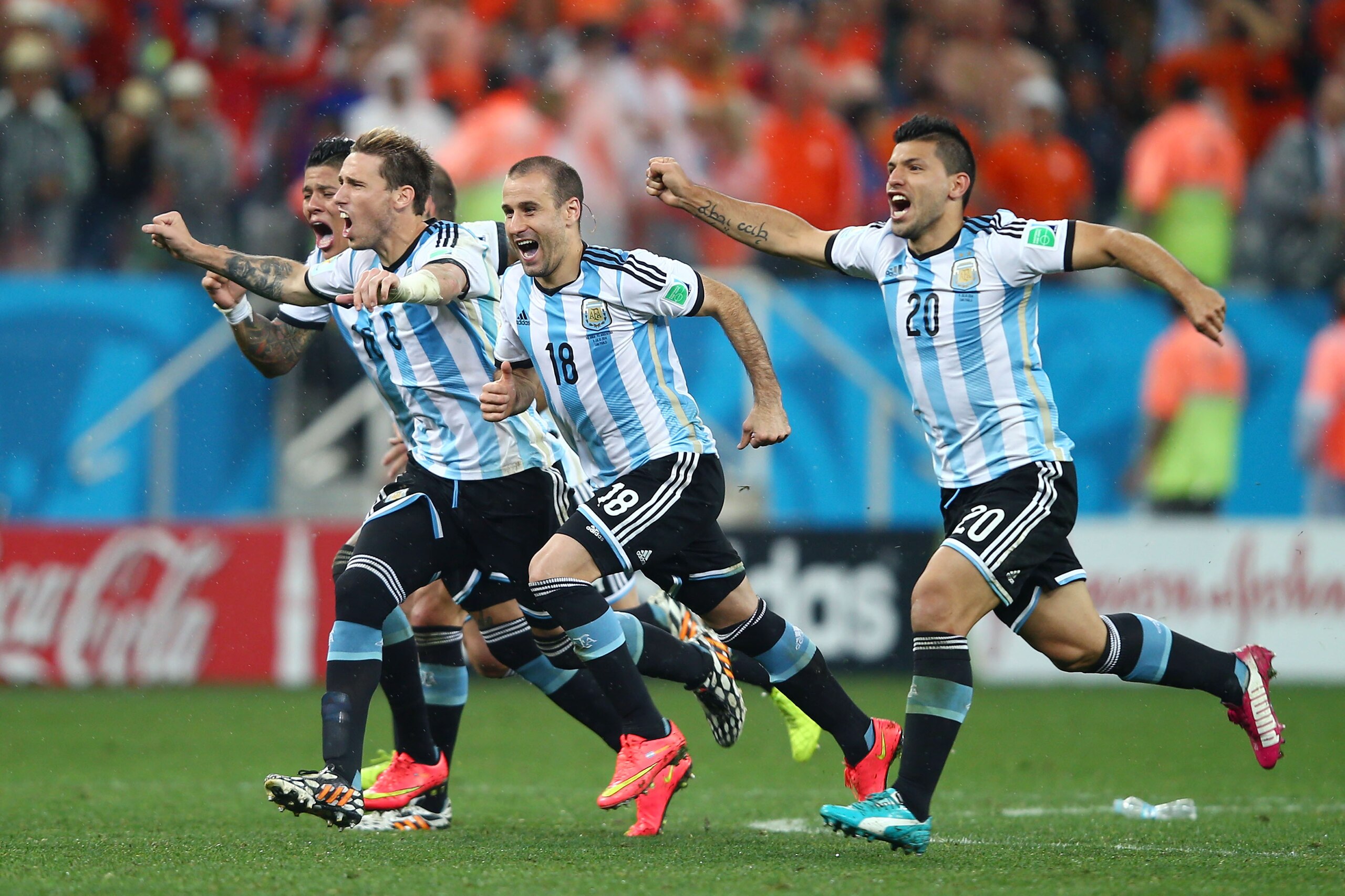 SAO PAULO, BRAZIL - JULY 09: (L-R) Marcos Rojo, Lucas Biglia, Rodrigo Palacio and Sergio Aguero of Argentina celebrate after defeating the Netherlands in a penalty shootout during the 2014 FIFA World Cup Brazil Semi Final match between the Netherlands and Argentina at Arena de Sao Paulo on July 9, 2014 in Sao Paulo, Brazil.  (Photo by Clive Rose/Getty Images)