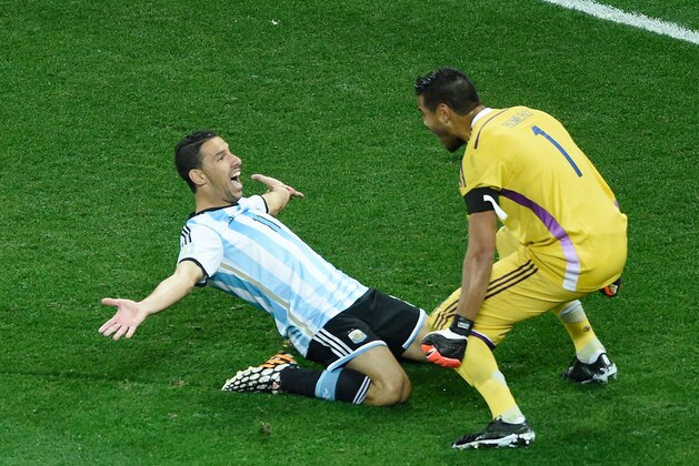 July 9, 2014; Sao Paulo, BRAZIL; Argentina player Maxi Rodriguez (left) celebrates with goalkeeper Sergio Romero after defeating the Netherlands during the semifinal match in the 2014 World Cup at Arena Corinthians.  Mandatory Credit: Tim Groothuis/Witters Sport via USA TODAY Sports