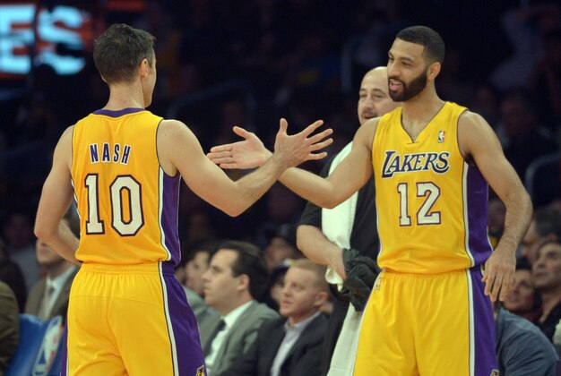 Apr 8, 2014; Los Angeles, CA, USA; Los Angeles Lakers guard Steve Nash (10) is congratulated by guard Kendall Marshall (12) after passing Mark Jackson (not pictured) to move into third on the all-time NBA assist list in the second quarter against the Houston Rockets at Staples Center. Mandatory Credit: Kirby Lee-USA TODAY Sports