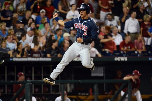 OMAHA, NE - JUNE 25:  Robert Refsnyder #2 of the Arizona Wildcats celebrates his run for a 2-1 lead over the South Carolina Gamecocks in the ninth inning during game 2 of the College World Series at TD Ameritrade Field on June 25, 2012 in Omaha, Nebraska.  (Photo by Harry How/Getty Images)