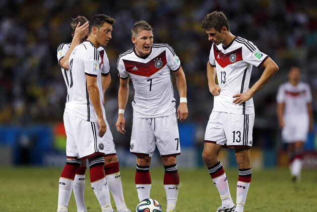 From left, Germany's Mesut Ozil, Toni Kroos, Miroslav Klose and Thomas Mueller stand over a free kick during the group G World Cup soccer match between Germany and Ghana at the Arena Castelao in Fortaleza, Brazil, Saturday, June 21, 2014.  (AP Photo/Frank Augstein)