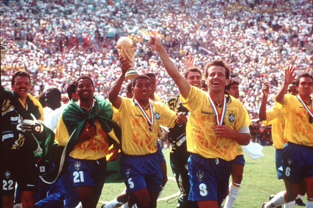 Members of Brazil's winning World Cup team parade around the Rose Bowl field in Pasadena, California, Sunday, July 17, 1994, after they defeated Italy in a penalty shootout, 3-2, before more than 94,000 spectators. From left are: Gilmar (22), Viola (21), Mauro Silva (5, with World Cup trophy), Dunga (8, who scored the winning goal), and Branco (6). The Brazilians took a record fourth title. (AP-PHOTO/stf/Bruno Luca)