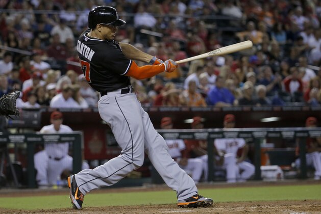Miami Marlins' Giancarlo Stanton hits gainst the Arizona Diamondbacks during the third inning of a baseball game, Tuesday, July 8, 2014, in Phoenix. (AP Photo/Matt York)