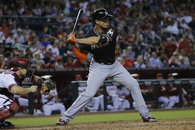 Florida Marlins' Giancarlo Stanton hits against the Arizona Diamondbacks during the second inning of a baseball game, Monday, July 7, 2014, in Phoenix. (AP Photo/Matt York)