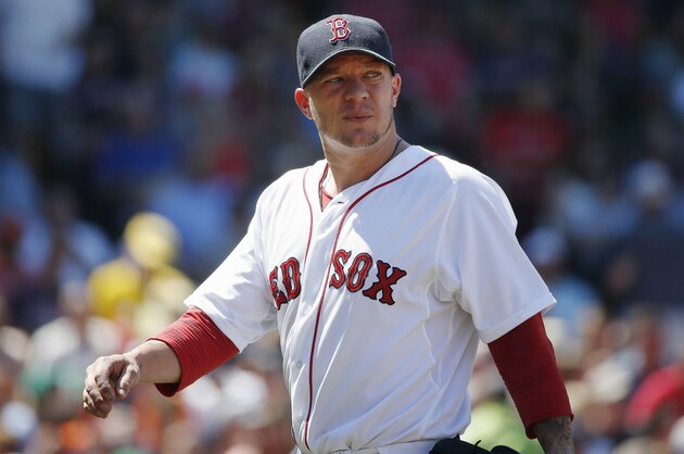 Boston Red Sox's Jake Peavy walks to the dug out after pitching in the fourth inning of a baseball game against the Baltimore Orioles in Boston, Sunday, July 6, 2014. (AP Photo/Michael Dwyer)