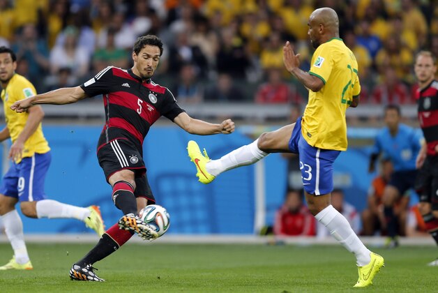 Germany's Mats Hummels, left, and Brazil's Maicon challenge for a ball during the World Cup semifinal soccer match between Brazil and Germany at the Mineirao Stadium in Belo Horizonte, Brazil, Tuesday, July 8, 2014. (AP Photo/Frank Augstein)