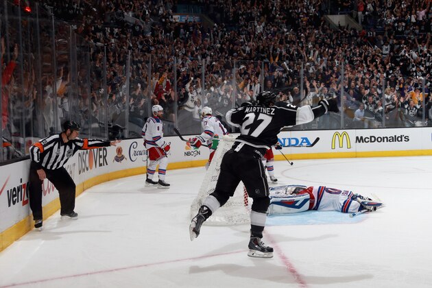 LOS ANGELES, CA - JUNE 13:  Alec Martinez #27 of the Los Angeles Kings celebrates after scoring the game-winning double overtime goal against goaltender Henrik Lundqvist #30 of the New York Rangers to win the Stanley Cup and Game Five of the 2014 Stanley Cup Final at the Staples Center on June 13, 2014 in Los Angeles, California. The Kings won the game 3-2 and win the series 4-1.  (Photo by Dave Sandford/NHLI via Getty Images)