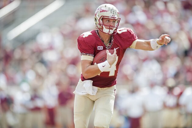 TALLAHASSEE, FL - OCTOBER 5: Jacob Coker #14 of the Florida State Seminoles calls for a hole during the second half against the Maryland Terrapins on October 5, 2013 at Doak Campbell Stadium in Tallahassee, Florida. Coker went to score and led the Seminoles to a 63-0 victory over the Terrapins. (Photo by Jeff Gammons/Getty Images)