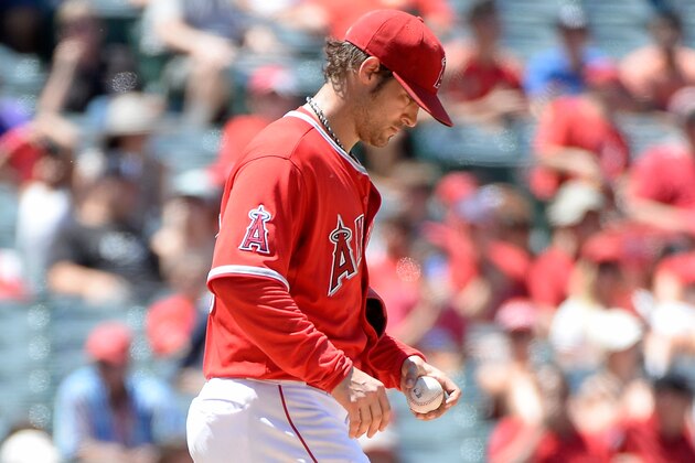ANAHEIM, CA - JULY 09:  C.J. Wilson #33 of the Los Angeles Angels reacts after a Steve Tolleson #18 of the Toronto Blue Jays single to score two runs and take a 4-3 lead during the fourth inning at Angel Stadium of Anaheim on July 9, 2014 in Anaheim, California.  (Photo by Harry How/Getty Images)