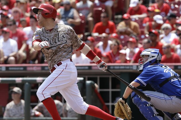 Cincinnati Reds' Todd Frazier hits a two-run home run off Toronto Blue Jays starting pitcher R.A. Dickey in the fifth inning of a baseball game, Sunday, June 22, 2014, in Cincinnati. (AP Photo/Al Behrman)