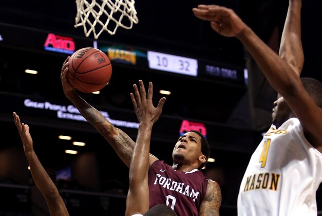 NEW YORK, NY - MARCH 12: Branden Frazier #0 of the Fordham Rams drives to the basket against Johnny Williams #2 of the George Mason Patriots in the first half during the first round of the Atlantic 10 Men's Basketball Tournament at Barclays Center on March 12, 2014 in the Brooklyn Borough of New York City.  (Photo by Mike Lawrie/Getty Images)