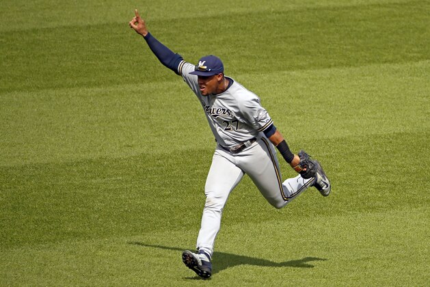 Milwaukee Brewers center fielder Carlos Gomez (27) celebrates after catching a fly ball to center field by Pittsburgh Pirates' Josh Harrison for the final out of the ninth inning of a baseball game in Pittsburgh Sunday, June 8, 2014. The Brewers won 1-0. (AP Photo/Gene J. Puskar)